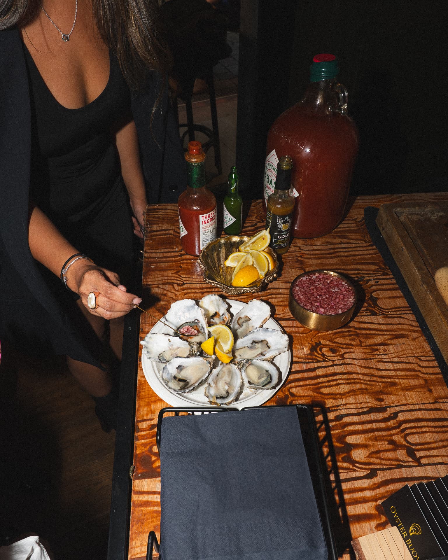 Guest dressing oysters with mignonette at Federico's Oyster event