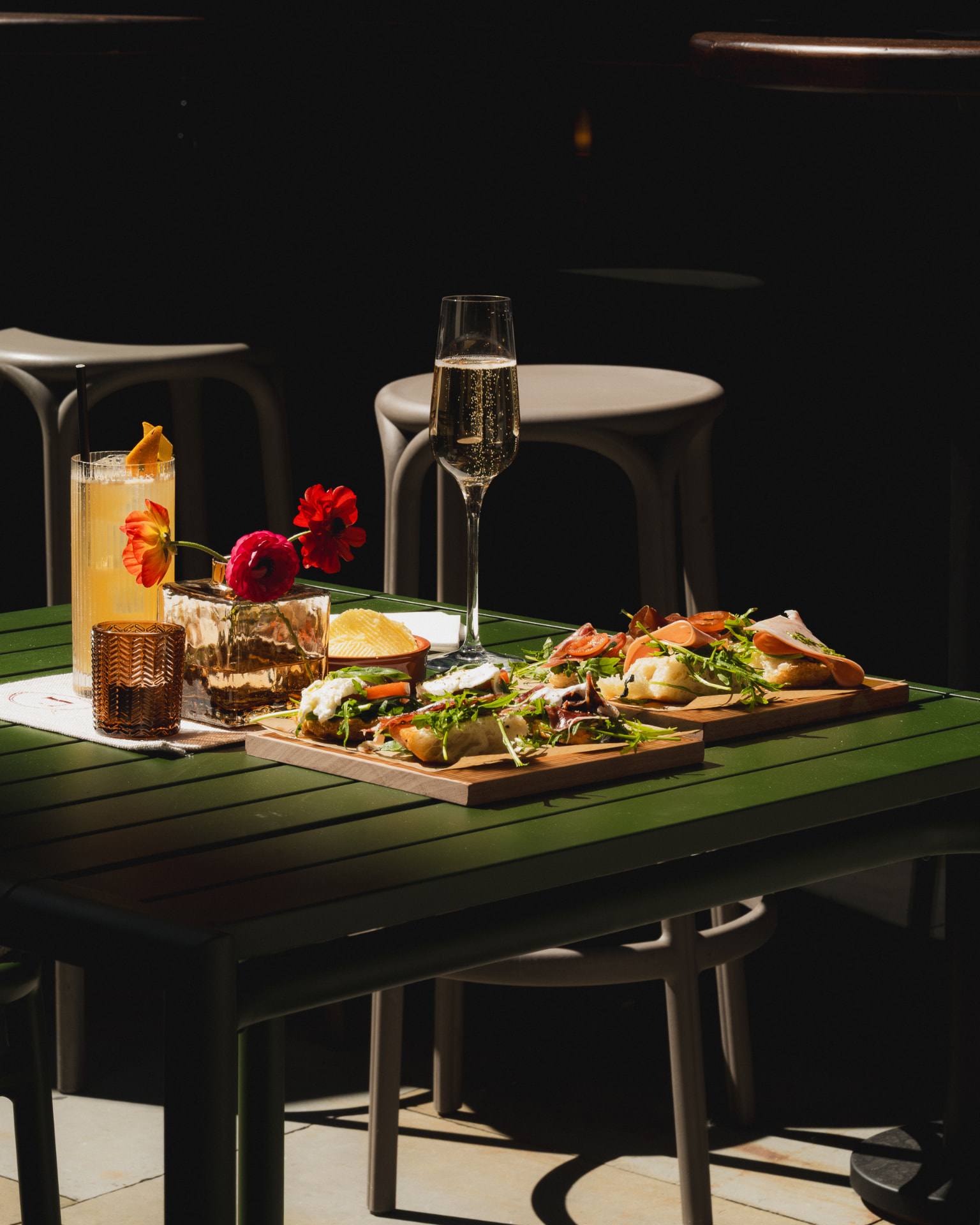 Champagne, cocktails and food on a Federico terrace table