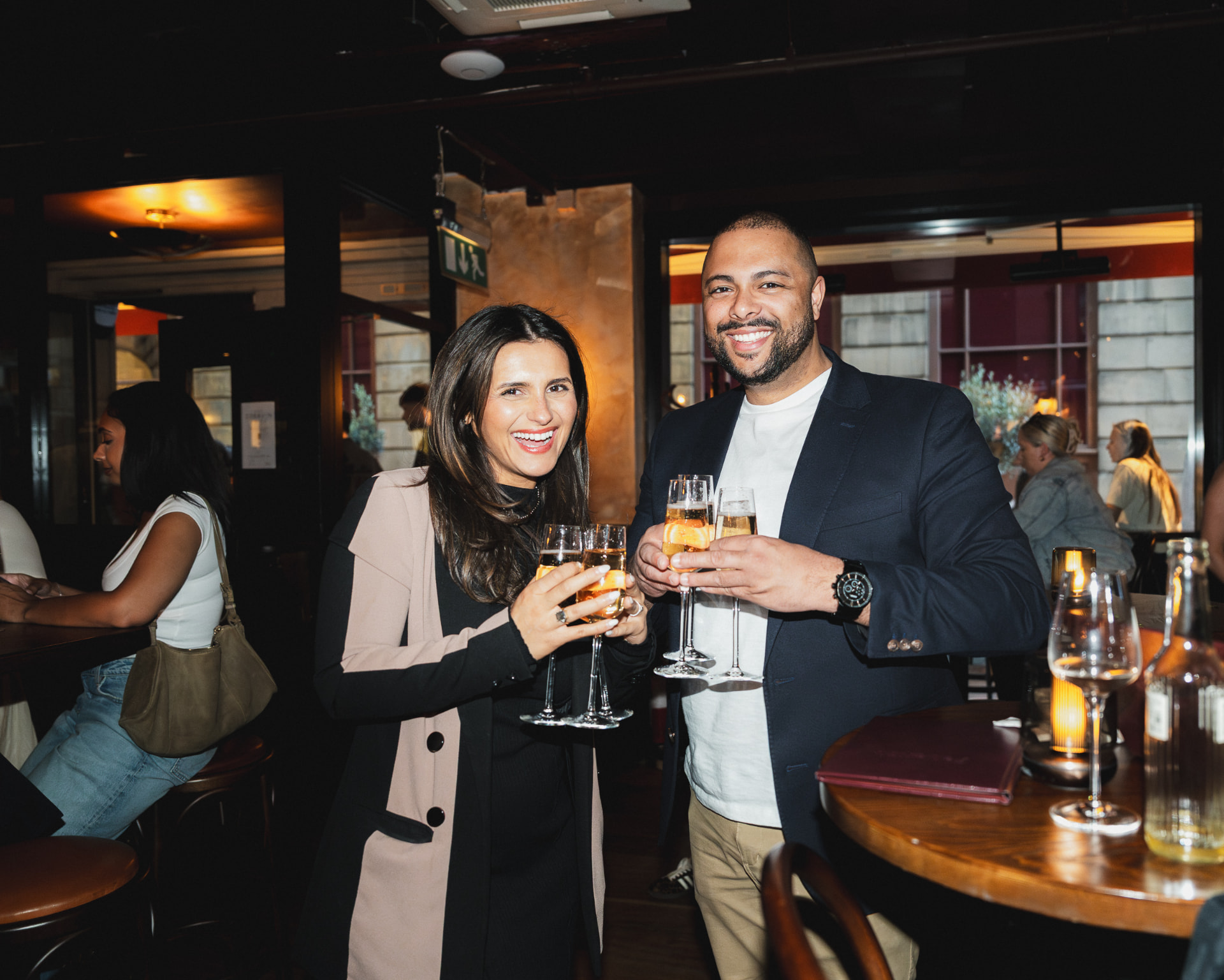 Two guests raising champagne glasses at Federico